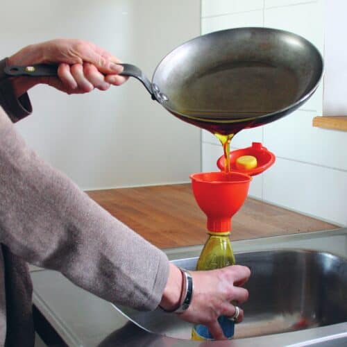 Pouring waste cooking oil into a funnel
